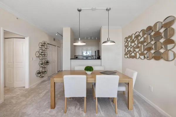 a view of a dining room with furniture and chandelier