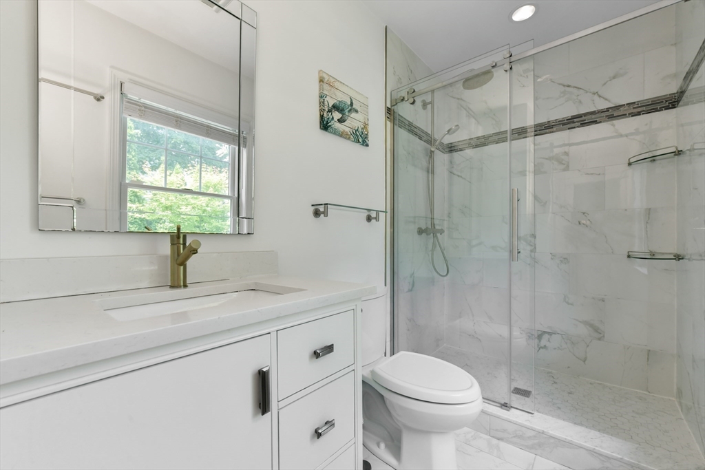 10 Farrow Street Winchester, MA 01890 - Photo 13 of 33 a bathroom with a shower sink vanity mirror and toilet