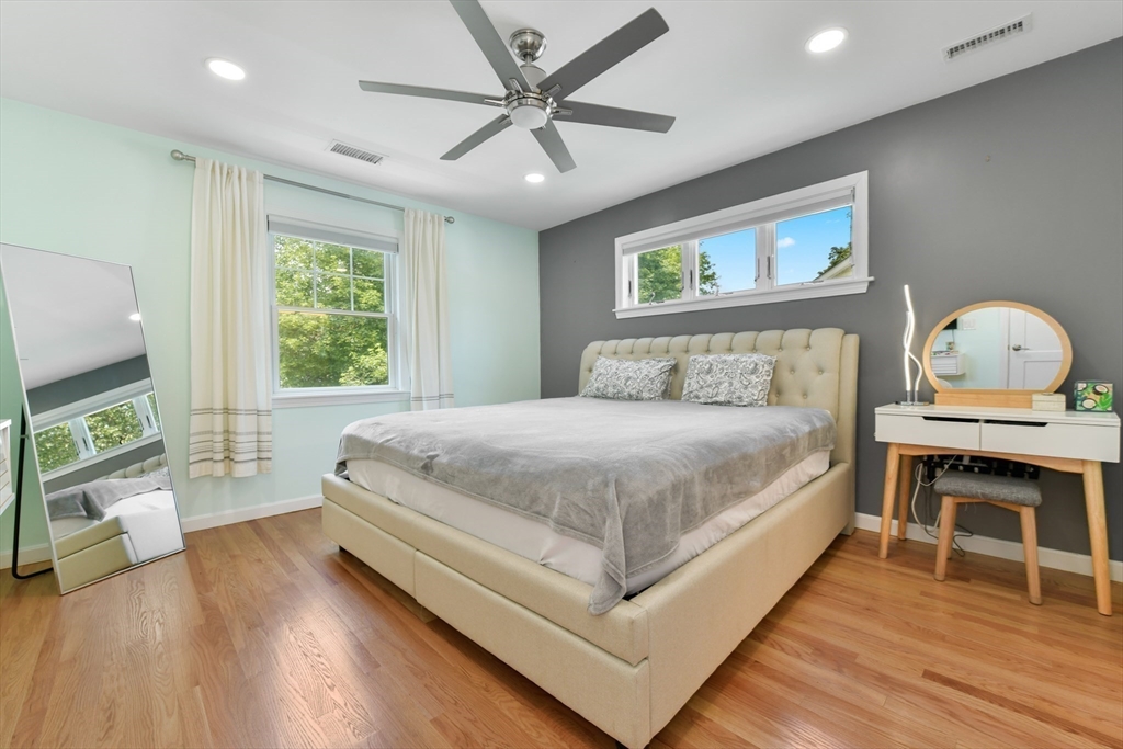 10 Farrow Street Winchester, MA 01890 - Photo 16 of 33 a bedroom with a bed and a flat screen tv