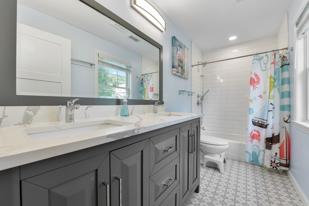 10 Farrow Street Winchester, MA 01890 - Photo 21 of 33 a bathroom with a granite countertop sink mirror vanity and toilet