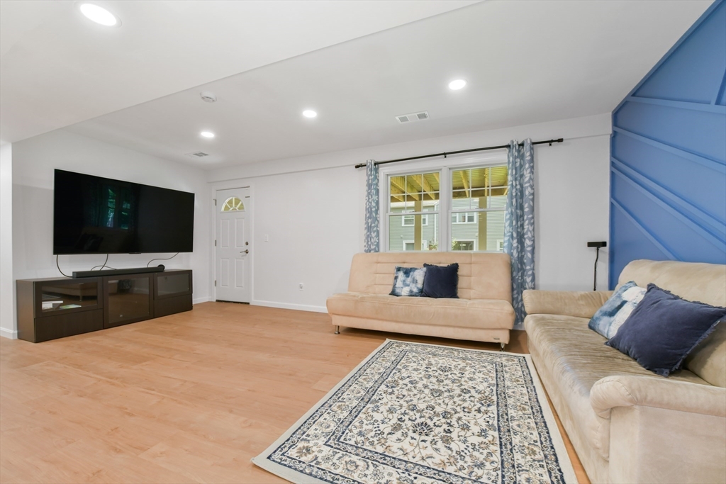 10 Farrow Street Winchester, MA 01890 - Photo 24 of 33 a living room with furniture and a flat screen tv