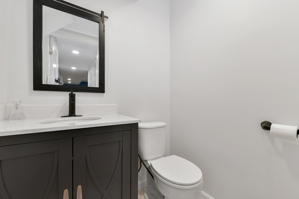 10 Farrow Street Winchester, MA 01890 - Photo 28 of 33 a bathroom with a toilet a sink and mirror