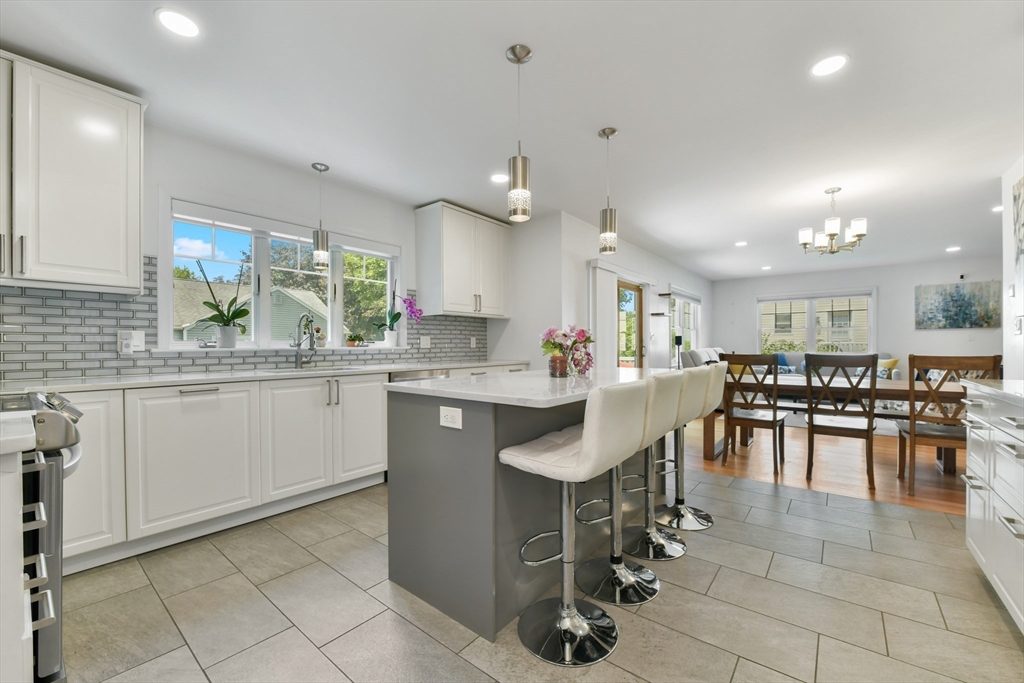 10 Farrow Street Winchester, MA 01890 - Photo 3 of 33 a kitchen with a dining table chairs sink and cabinets