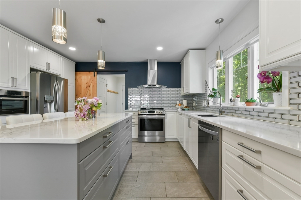 10 Farrow Street Winchester, MA 01890 - Photo 5 of 33 a large kitchen with a large counter top a sink stainless steel appliances and cabinets