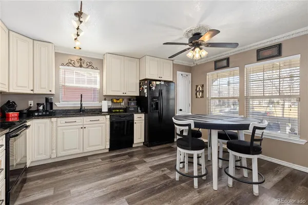 a kitchen with a table chairs stove and refrigerator