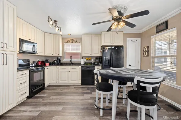 a kitchen with a stove cabinets and window