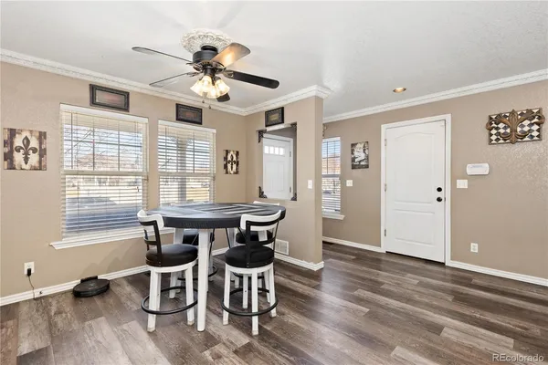 a view of a dining room with furniture window and wooden floor