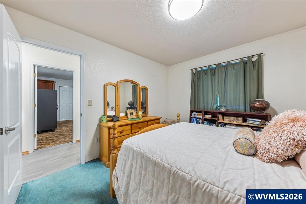 6100 Teal Creek Road Dallas, OR 97338 - Photo 21 of 41 a bedroom with a bed and dresser