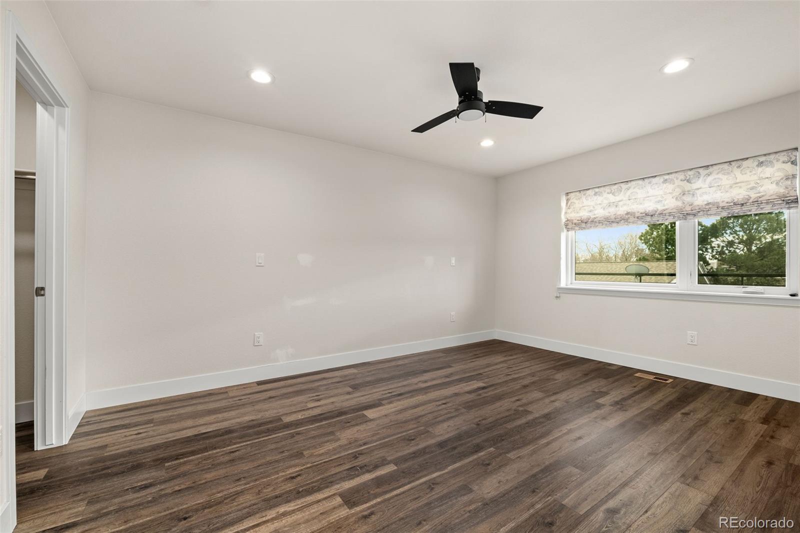 1204 South Reed Street Lakewood, CO 80232 - Photo 39 of 45 a view of an empty room with wooden floor and a window
