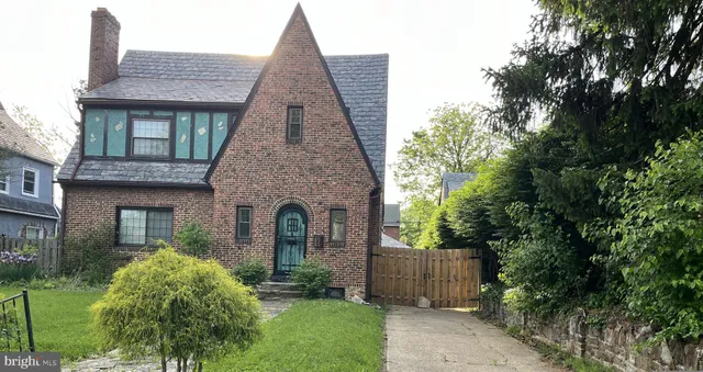 a front view of a house with a garden and plants