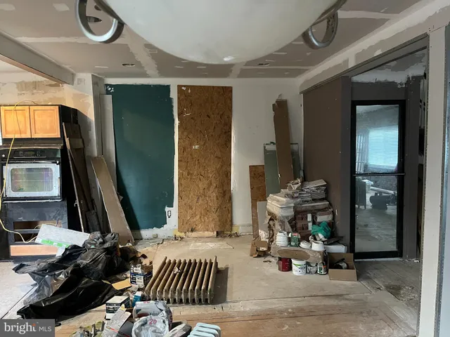 a kitchen with granite countertop a stove and cabinets
