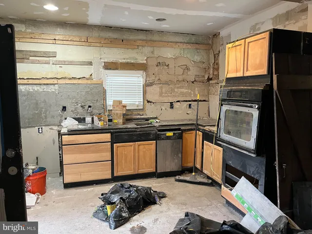 a view of a chair and table in backyard of the house