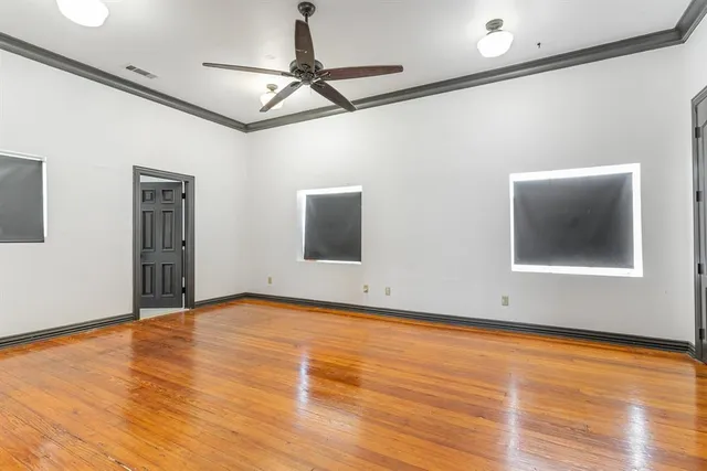 a view of an entryway with wooden floor and door