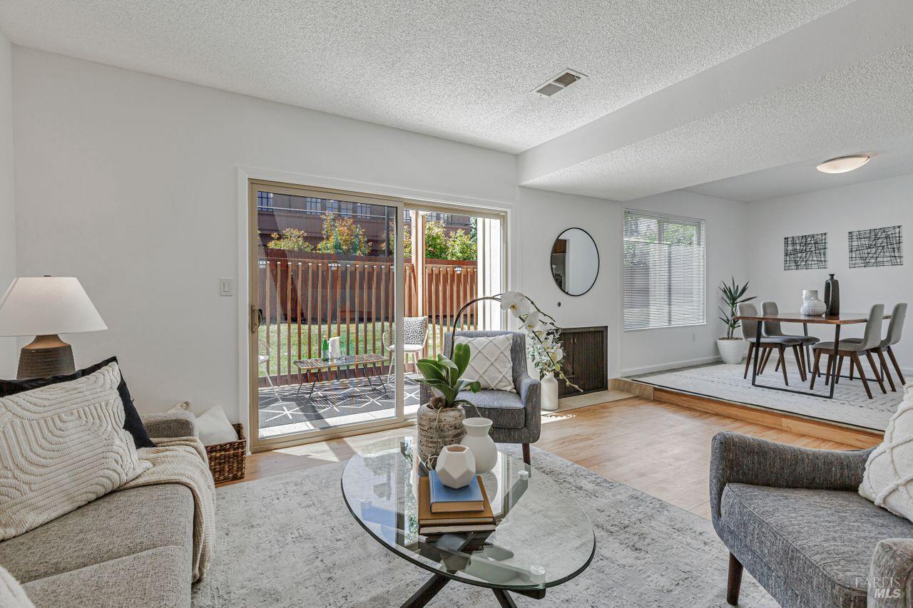 a living room with furniture a fireplace and a potted plant
