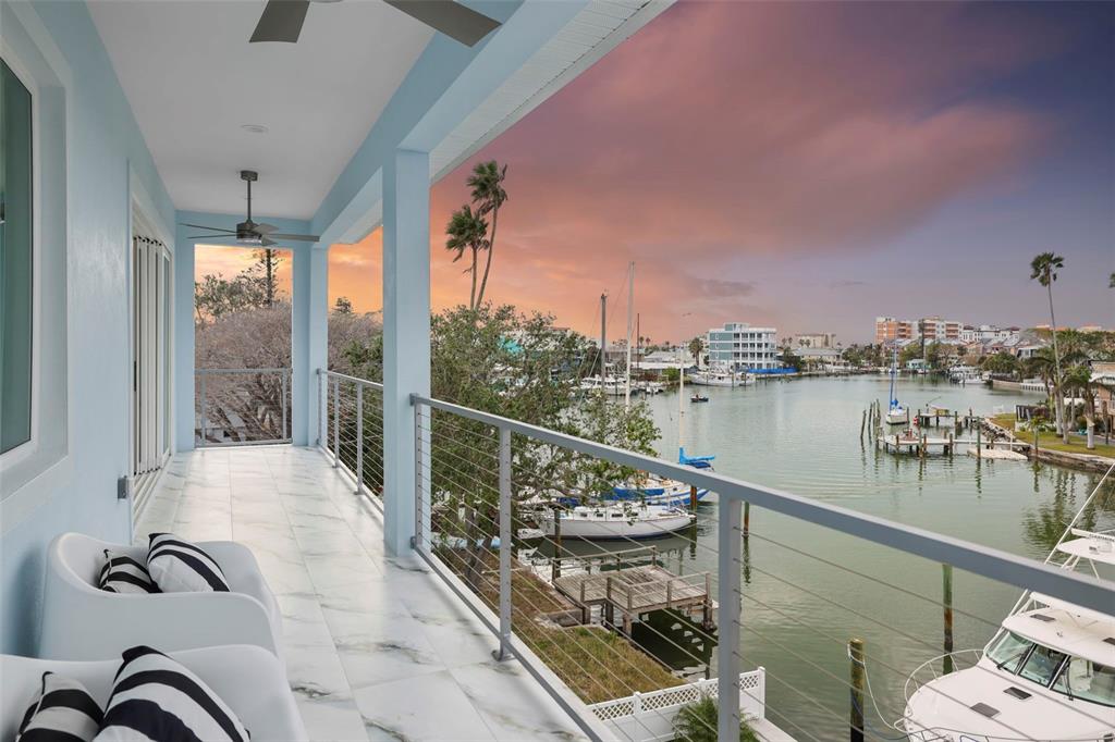 326 129th Avenue East Madeira Beach, FL 33708 - Photo 1 of 1 a balcony with table and chairs