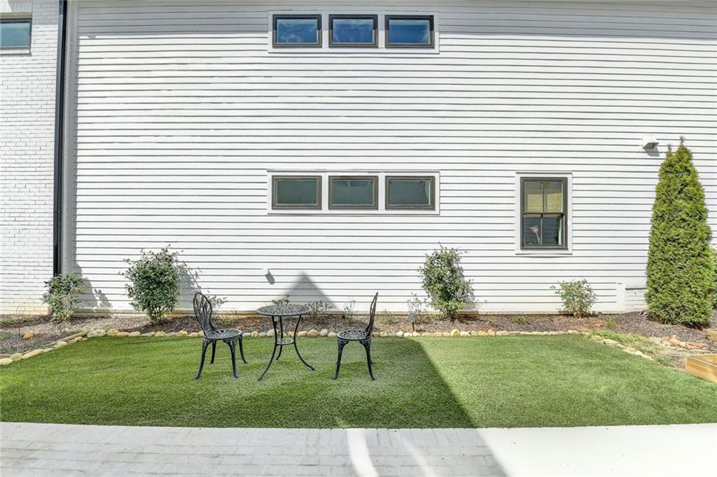 6785 Halcyon Way Alpharetta, GA 30005 - Photo 13 of 90 a view of a house with a yard and a garden