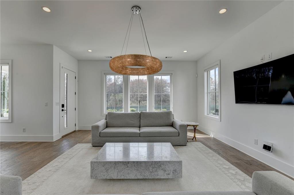 6785 Halcyon Way Alpharetta, GA 30005 - Photo 17 of 90 a living room with furniture and a flat screen tv