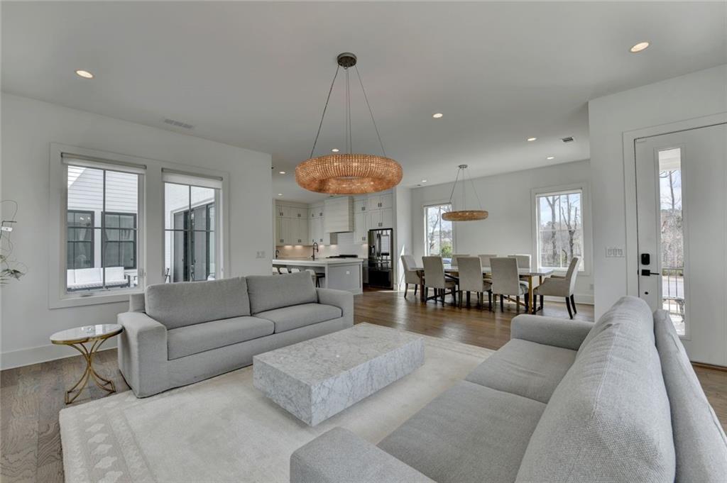 6785 Halcyon Way Alpharetta, GA 30005 - Photo 19 of 90 a living room with furniture a chandelier and a large window