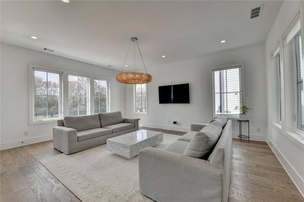 6785 Halcyon Way Alpharetta, GA 30005 - Photo 23 of 90 a living room with furniture and a flat screen tv