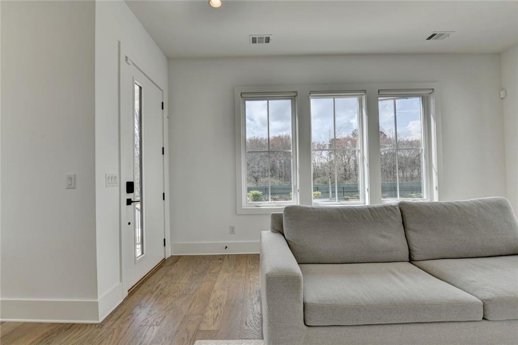 6785 Halcyon Way Alpharetta, GA 30005 - Photo 24 of 90 a living room with furniture and a large window