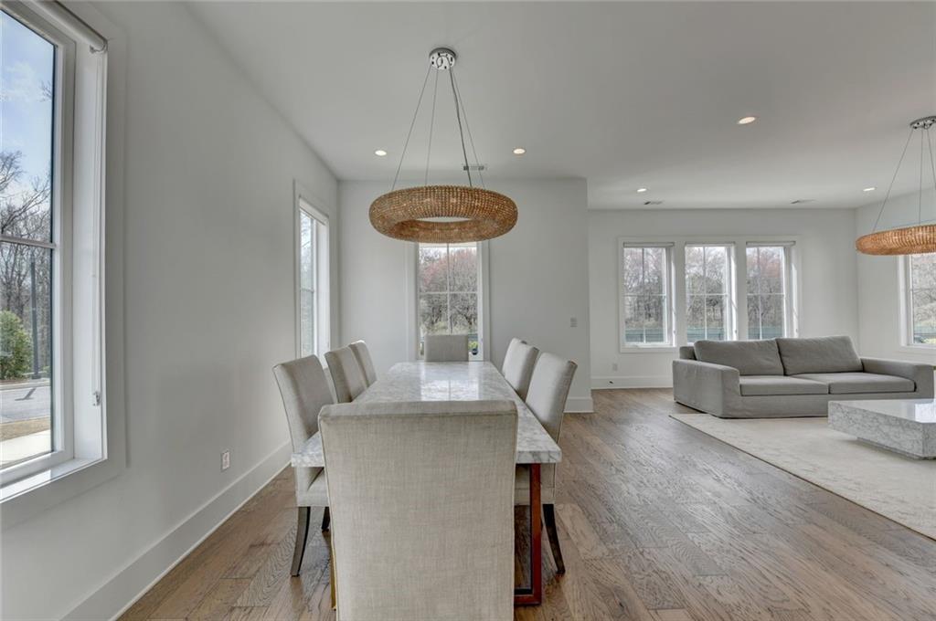 6785 Halcyon Way Alpharetta, GA 30005 - Photo 25 of 90 a dining room with furniture a chandelier and wooden floor