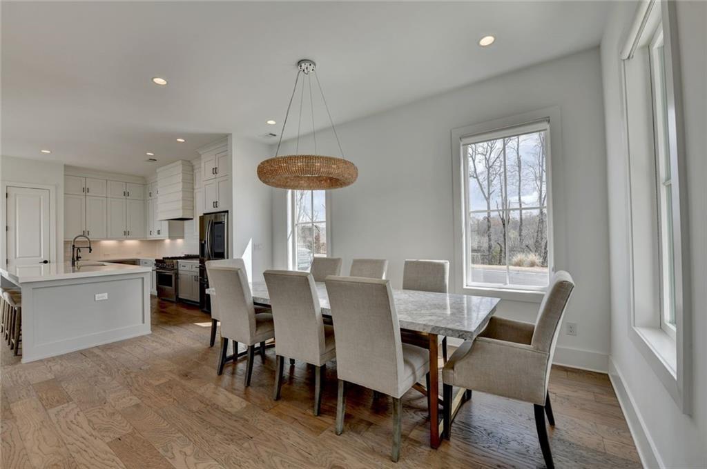 6785 Halcyon Way Alpharetta, GA 30005 - Photo 26 of 90 a view of a dining room with furniture window and wooden floor