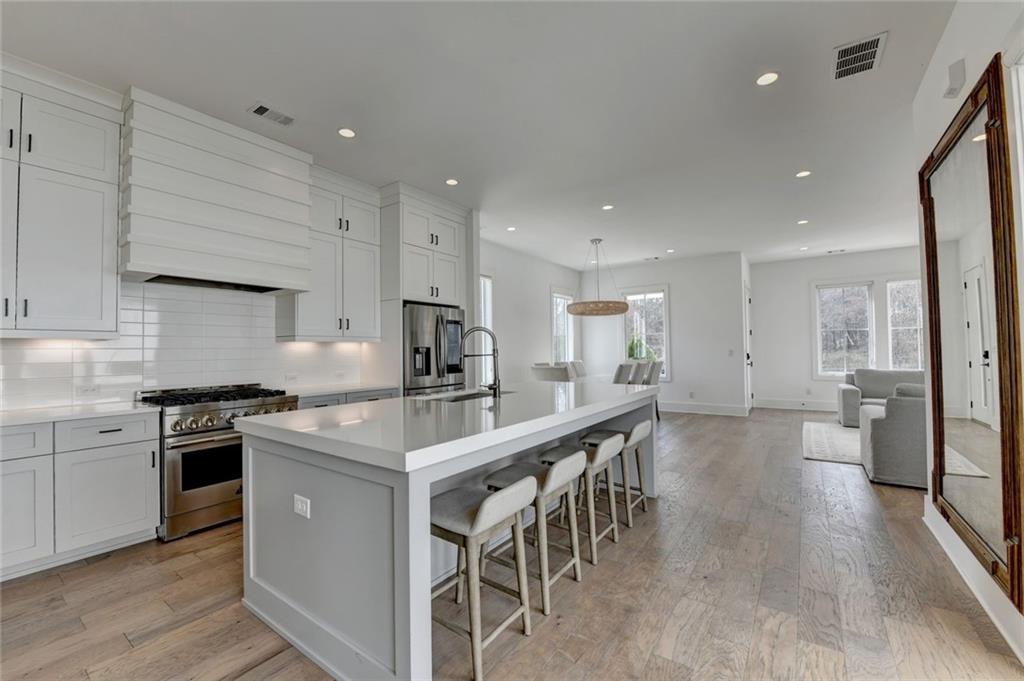 6785 Halcyon Way Alpharetta, GA 30005 - Photo 30 of 90 a kitchen with appliances a sink a counter top space and cabinets