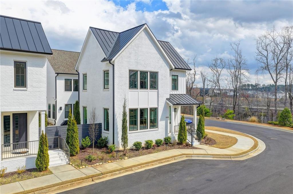 6785 Halcyon Way Alpharetta, GA 30005 - Photo 3 of 90 a front view of a house with garden