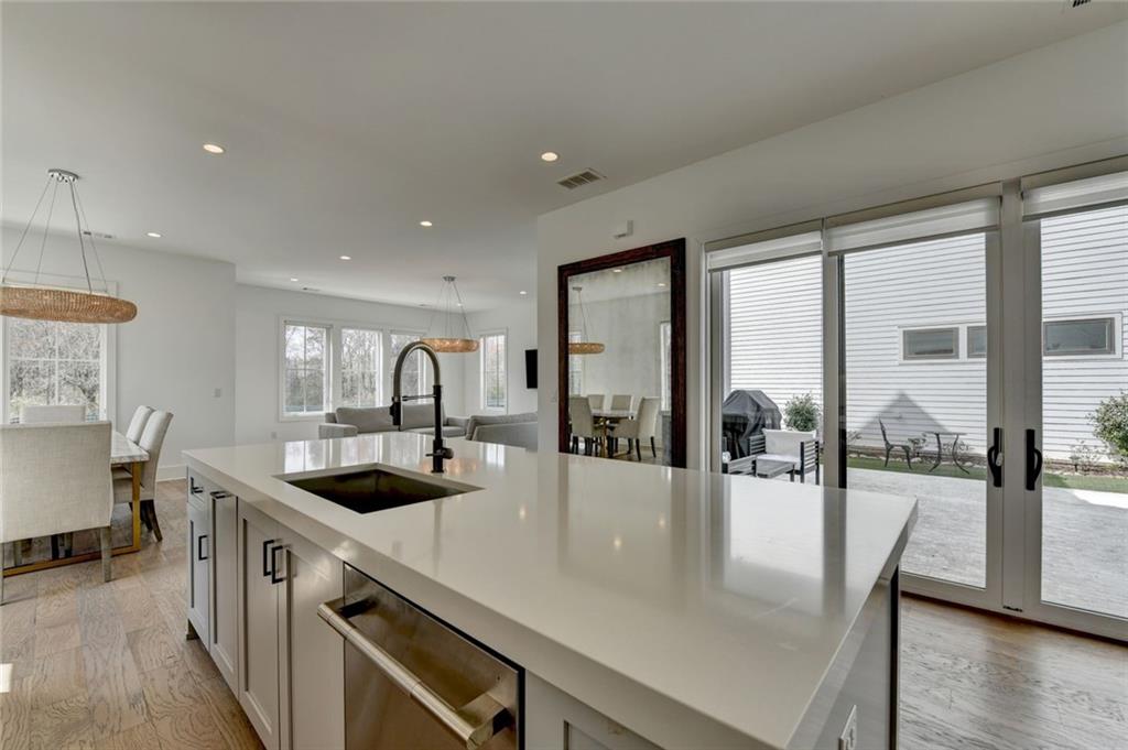 6785 Halcyon Way Alpharetta, GA 30005 - Photo 34 of 90 a kitchen with a stove and a view of living room