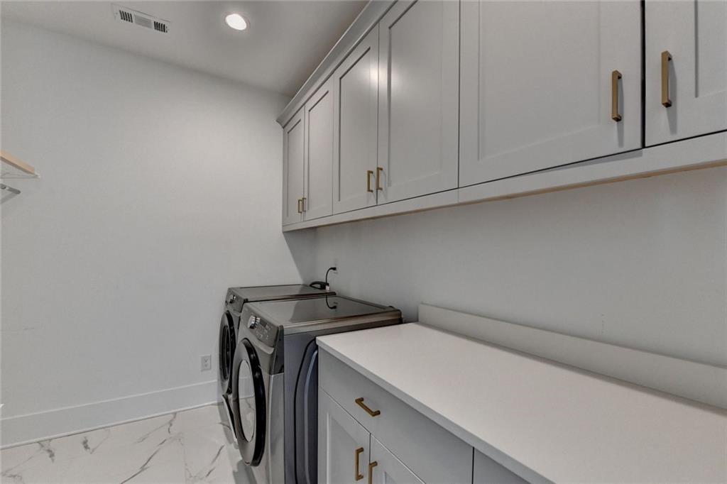 6785 Halcyon Way Alpharetta, GA 30005 - Photo 50 of 90 a utility room with dryer and washer