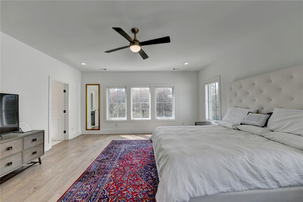 6785 Halcyon Way Alpharetta, GA 30005 - Photo 58 of 90 a spacious bedroom with a large bed and a flat screen tv