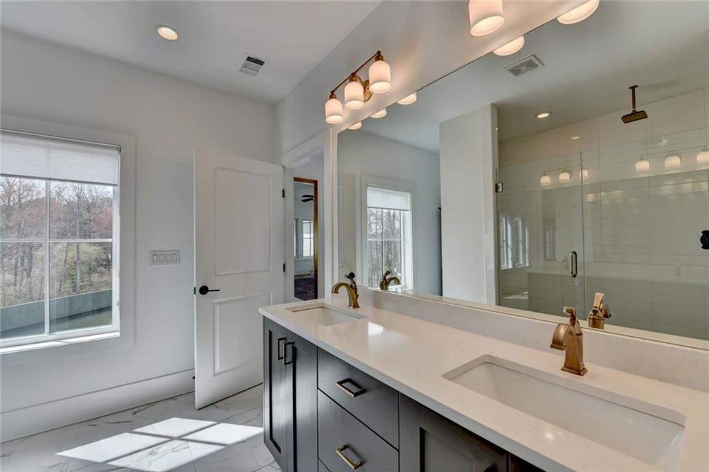 6785 Halcyon Way Alpharetta, GA 30005 - Photo 60 of 90 a bathroom with a sink a two mirror and a window
