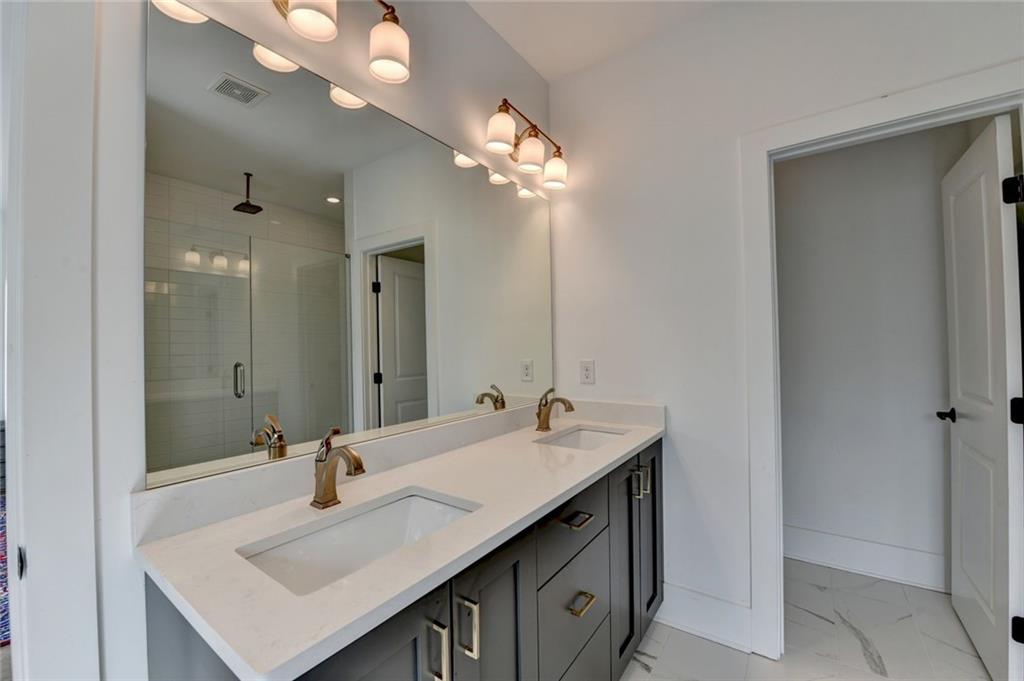 6785 Halcyon Way Alpharetta, GA 30005 - Photo 62 of 90 a bathroom with a sink double vanity and a mirror
