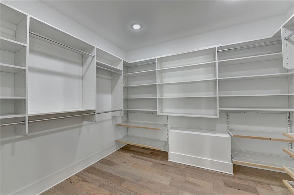 6785 Halcyon Way Alpharetta, GA 30005 - Photo 65 of 90 a view of walk in closet with empty racks