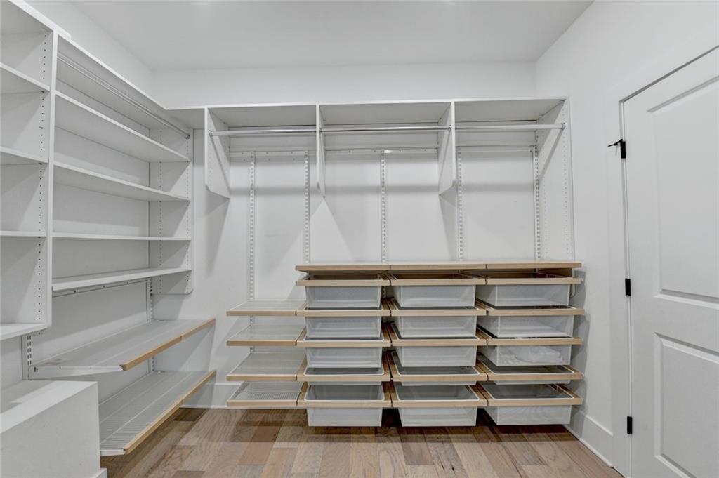 6785 Halcyon Way Alpharetta, GA 30005 - Photo 66 of 90 a view of walk in closet with empty racks