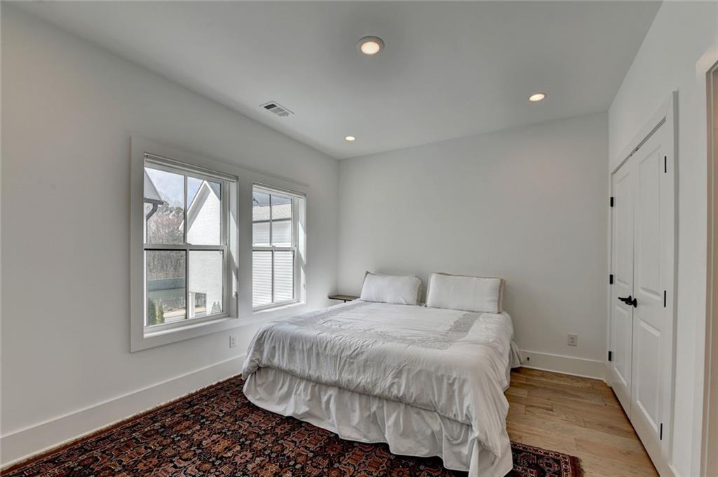 6785 Halcyon Way Alpharetta, GA 30005 - Photo 67 of 90 a bedroom with a bed and a window