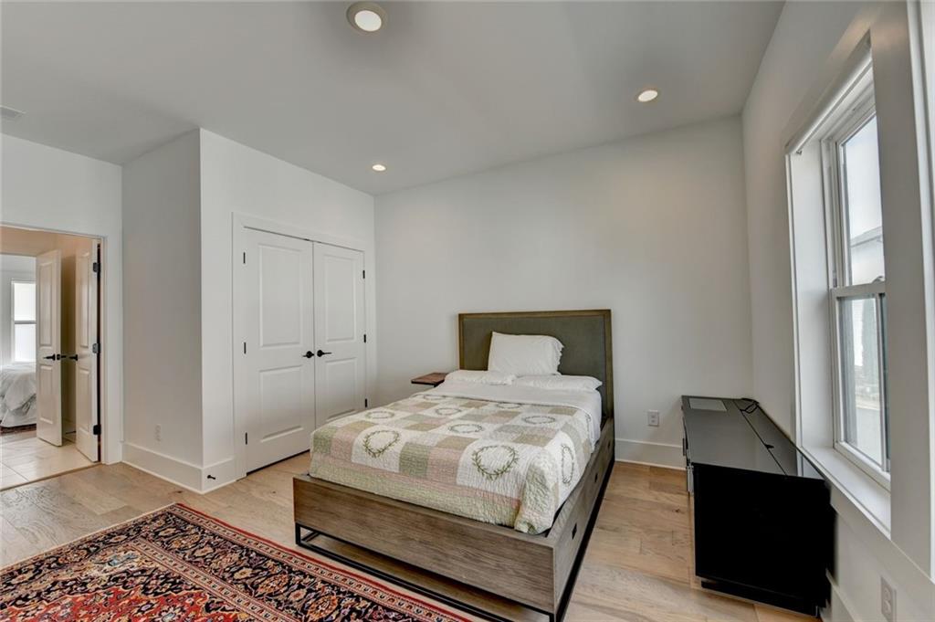 6785 Halcyon Way Alpharetta, GA 30005 - Photo 72 of 90 a bedroom with a bed and wooden floor