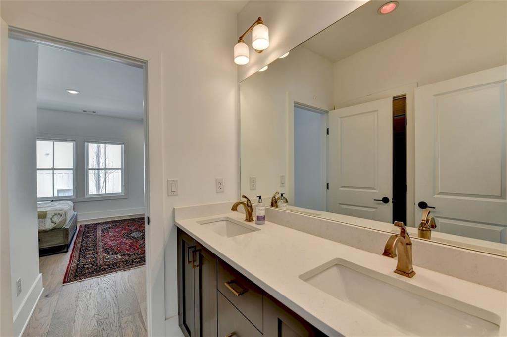 6785 Halcyon Way Alpharetta, GA 30005 - Photo 75 of 90 a bathroom with double vanity and a mirror