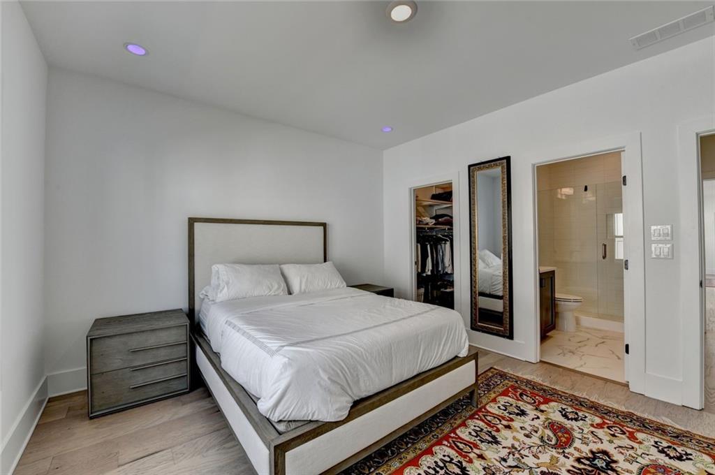 6785 Halcyon Way Alpharetta, GA 30005 - Photo 77 of 90 a bedroom with a bed and wooden floor