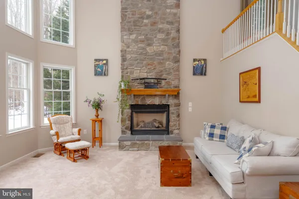 a kitchen with stainless steel appliances granite countertop a stove a sink dishwasher and a refrigerator with wooden floor