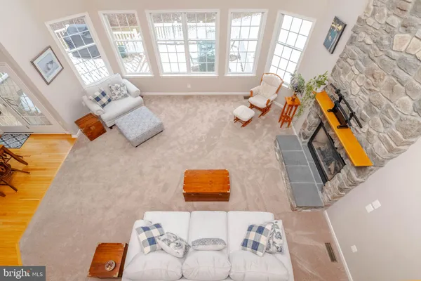 a living room with furniture a fireplace and a dining table with rug