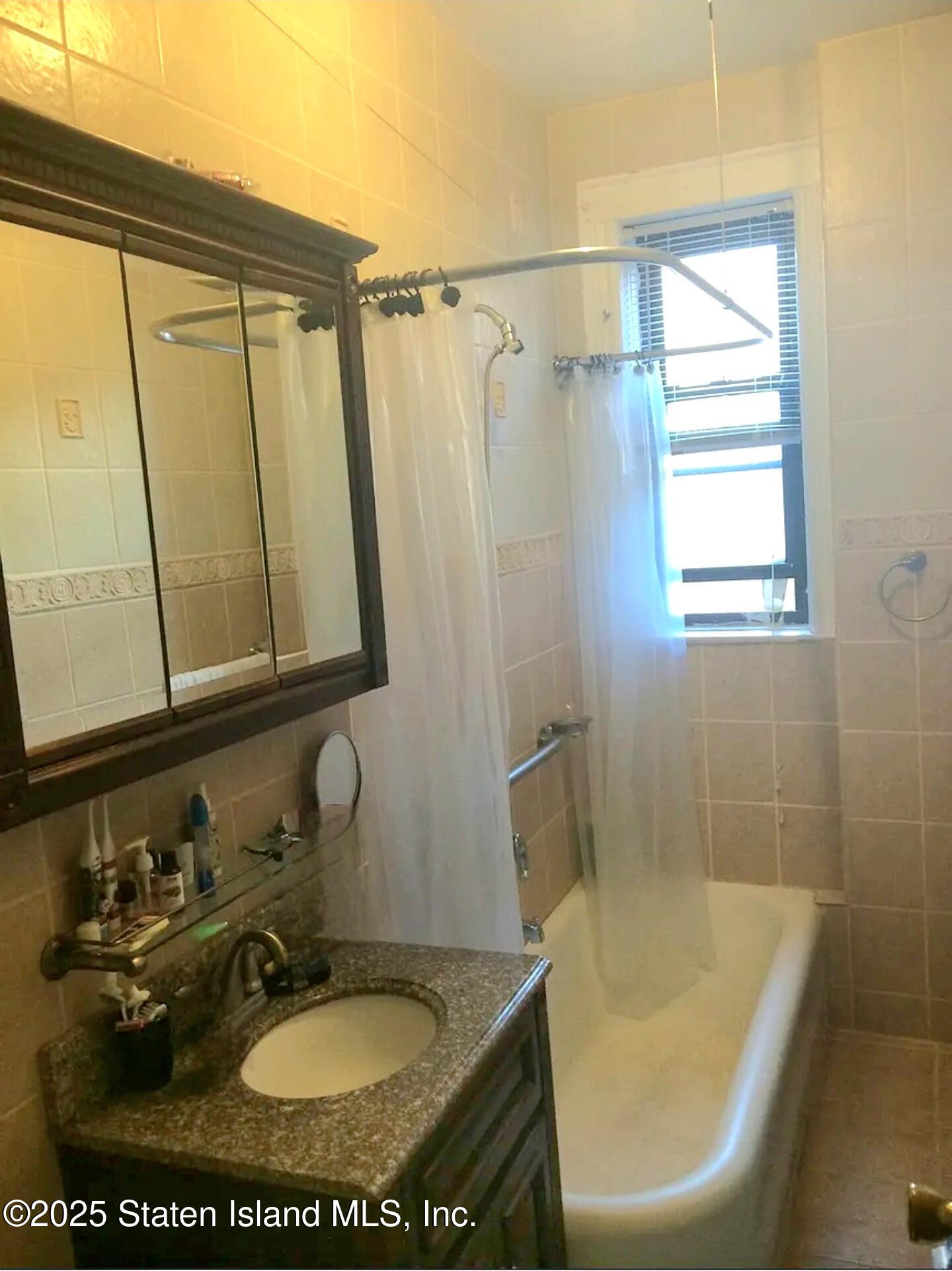3039 Ocean Parkway, Unit D5 Brooklyn, NY 11235 - Photo 7 of 7 a bathroom with a sink toilet and shower