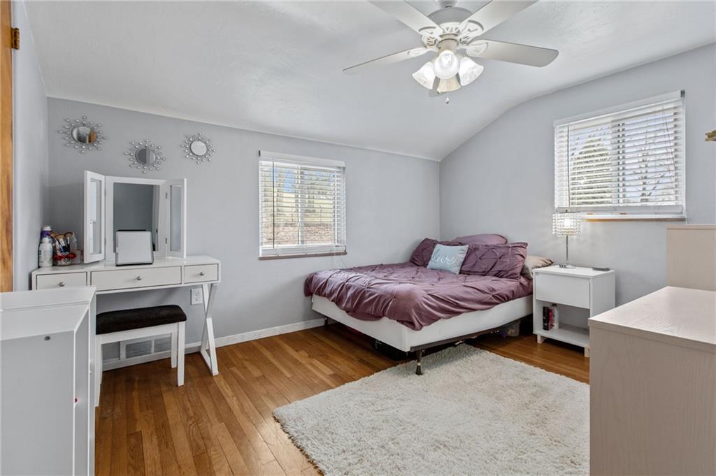 1488 Anderson Road Pittsburgh, PA 15209 - Photo 11 of 18 a spacious bedroom with a bed and a chandelier