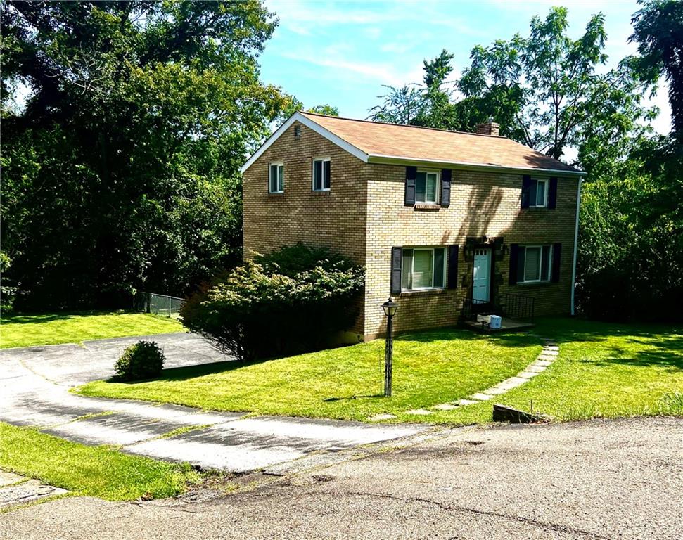 1488 Anderson Road Pittsburgh, PA 15209 - Photo 18 of 18 a front view of a house with a yard and garage