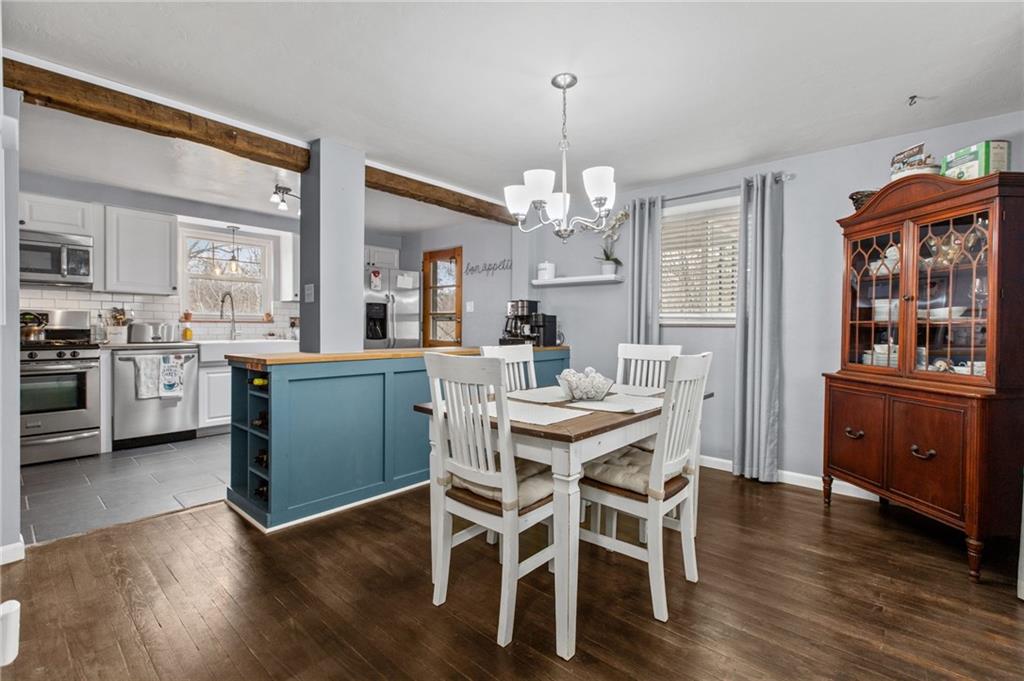1488 Anderson Road Pittsburgh, PA 15209 - Photo 5 of 18 a view of a dining room and livingroom with furniture wooden floor a chandelier