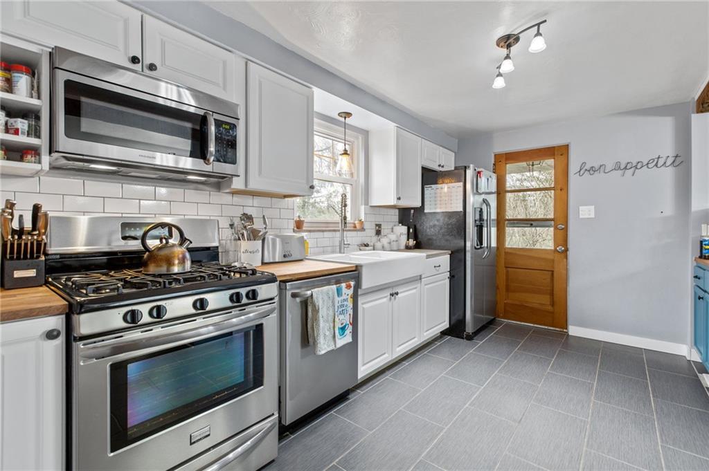 1488 Anderson Road Pittsburgh, PA 15209 - Photo 6 of 18 a kitchen with stainless steel appliances a stove microwave and sink
