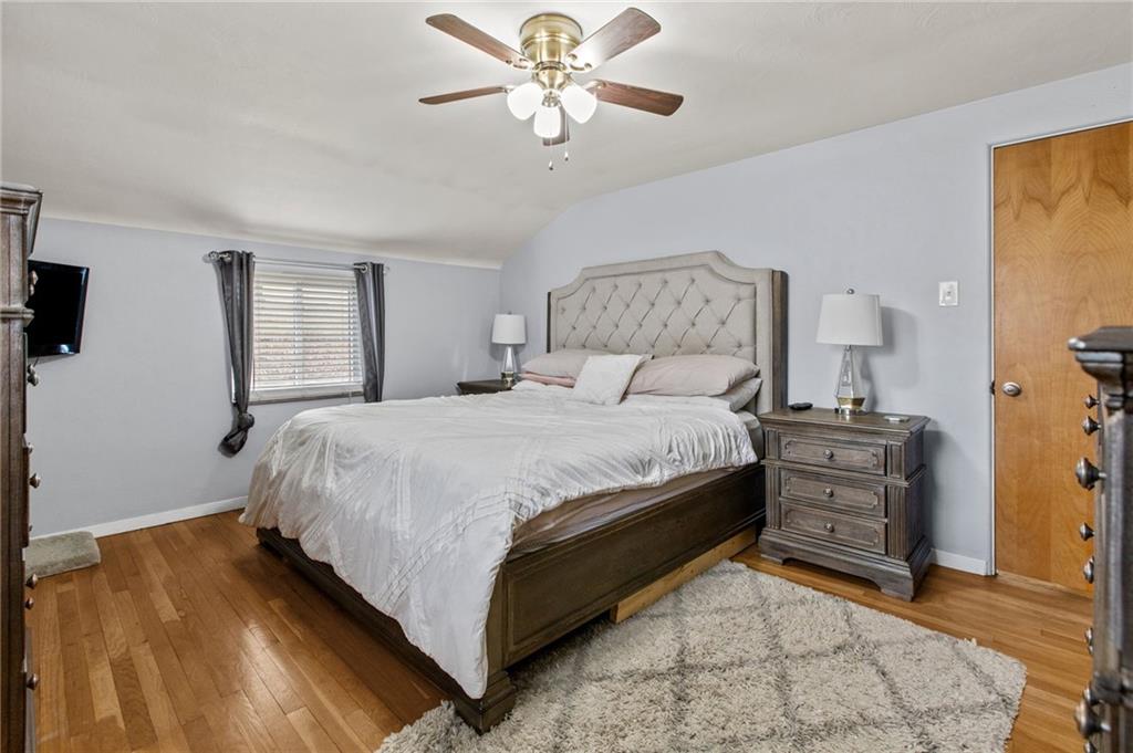 1488 Anderson Road Pittsburgh, PA 15209 - Photo 9 of 18 a bedroom with a bed and a chandelier