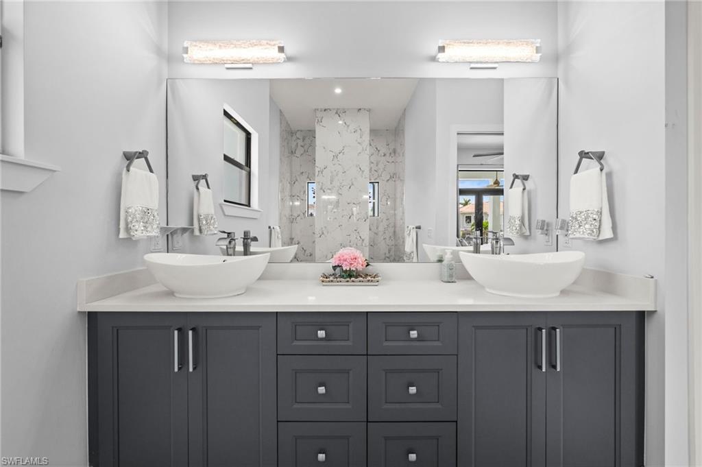 388 Pine Avenue Naples, FL 34108 - Photo 23 of 34 a bathroom with a granite countertop sink double vanity and a mirror