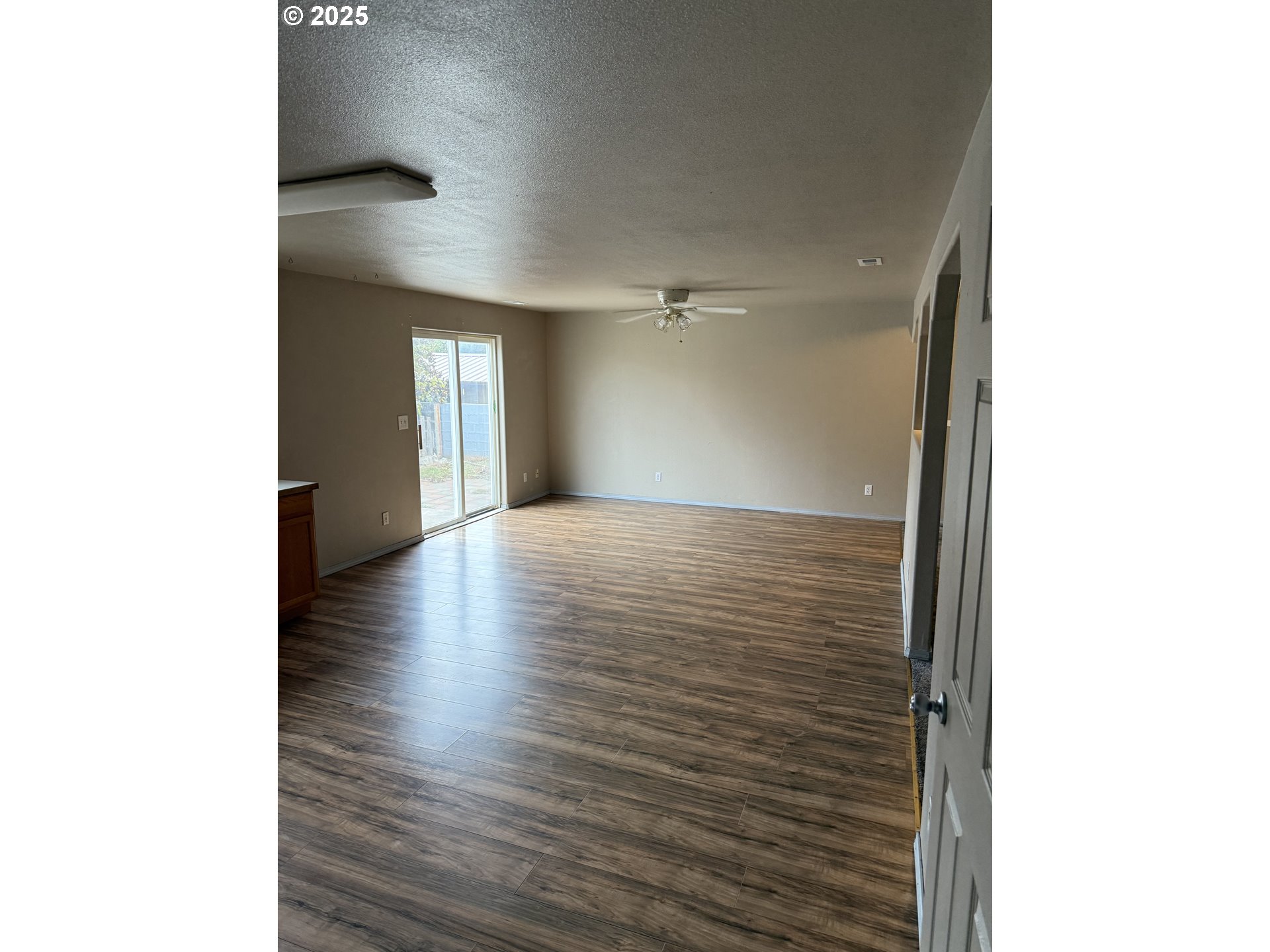 2464 Blue Jay Way Umatilla, OR 97882 - Photo 2 of 39 a view of a hallway with wooden floor