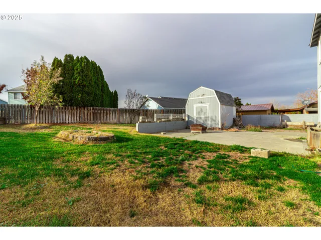 a view of a swimming pool with a yard and a fountain